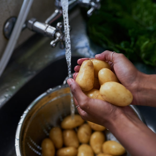 woman washing potatoes