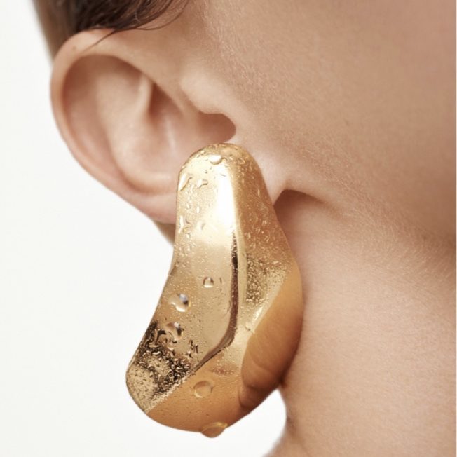 woman wearing gold earring